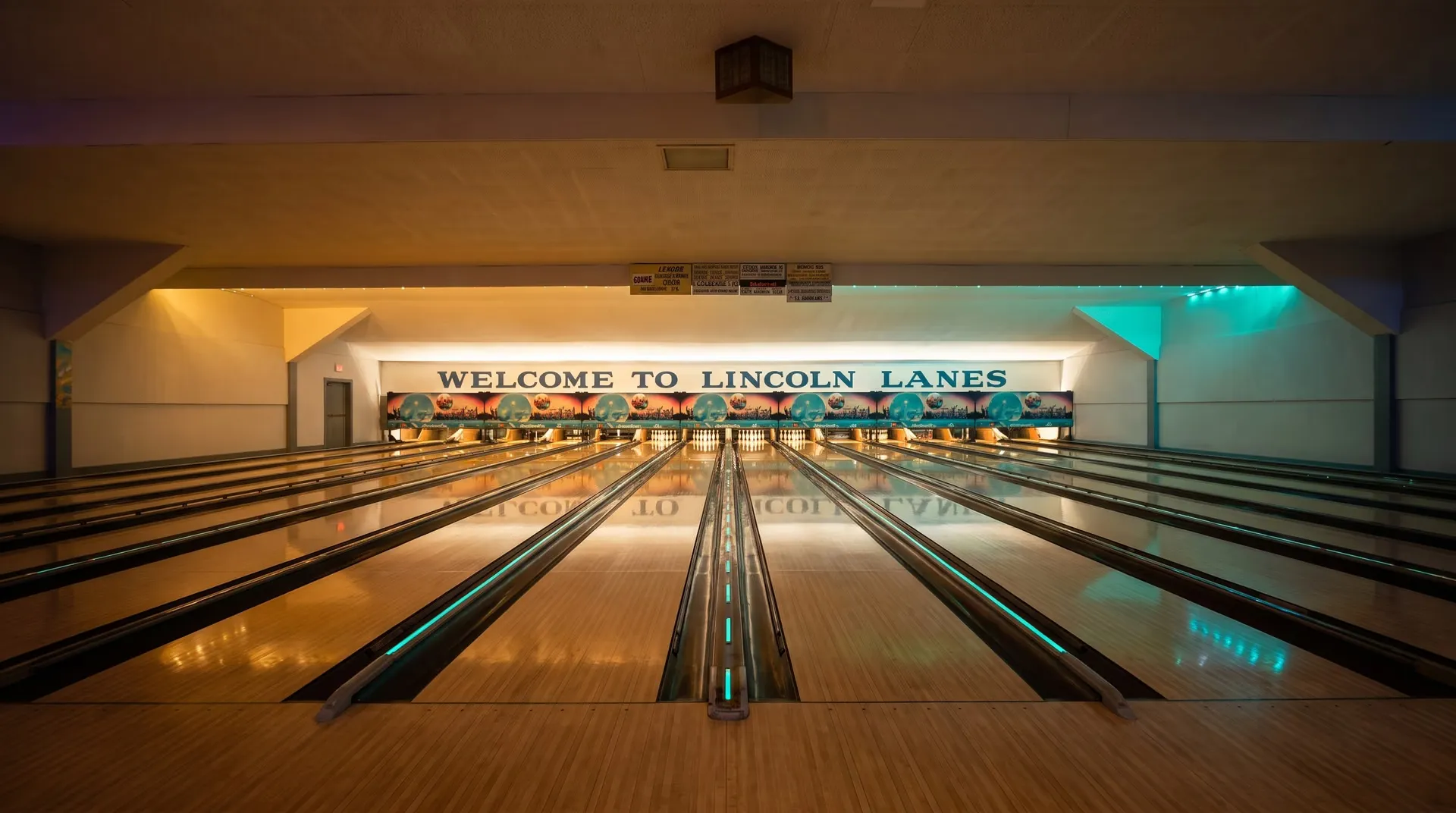 Looking down the polished maple lanes toward the glowing Welcome to Lincoln Lanes sign