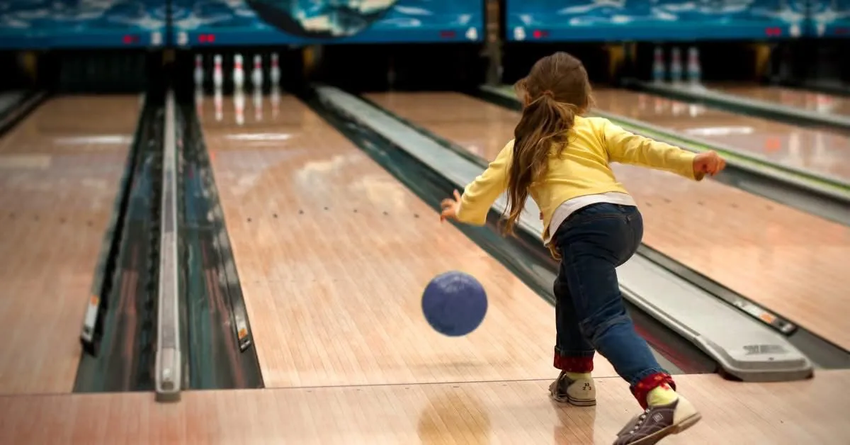 A young bowler rolling a ball down the maple lanes at Lincoln Lanes in Vernon