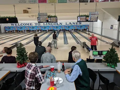 A busy community league night with bowlers of all ages under the Welcome to Lincoln Lanes sign